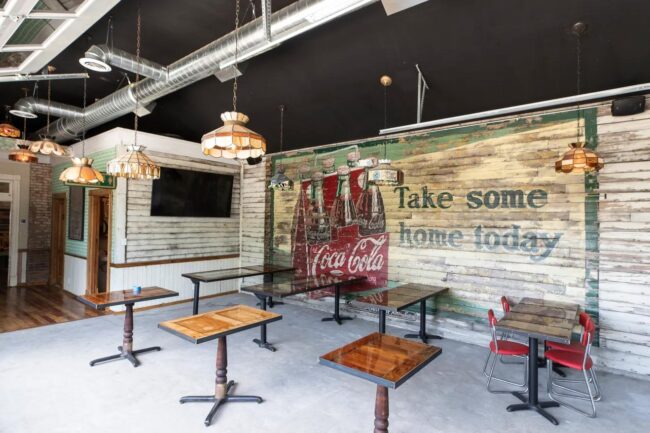 A large Coca-Cola sign was removed from the exterior wall and placed in the dining area of the new bar.