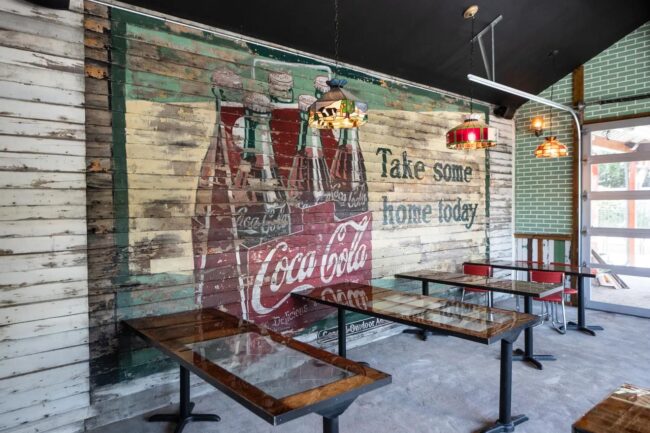 A large Coca-Cola sign was removed from the exterior wall and placed in the dining area of the new bar.