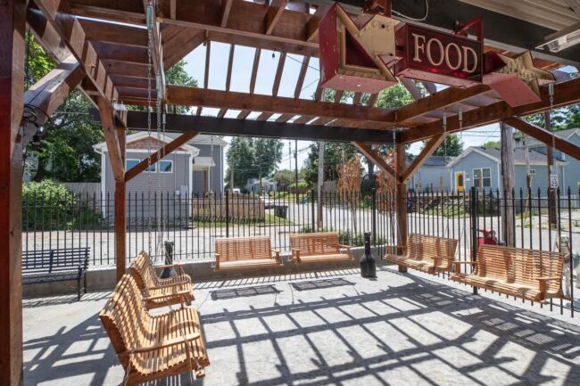 An outdoor space feature front porch swings.