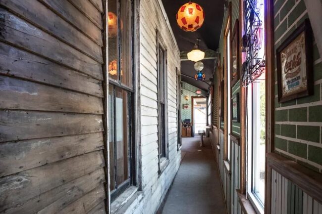 A hallway leads from the bar to a Daily museum and dining area.